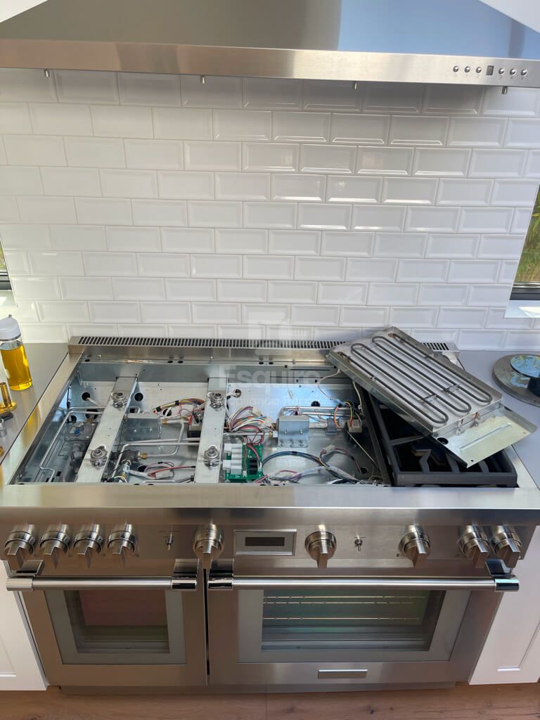 Esquire Appliance Repair technician working on a cooktop in Orange County