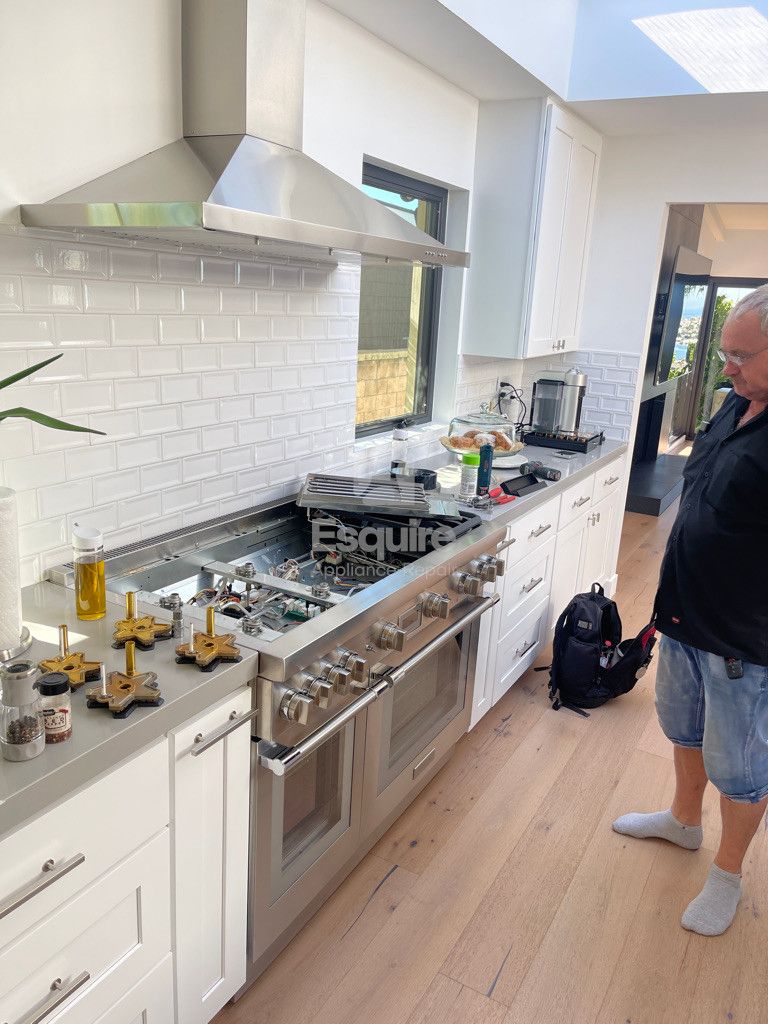 Esquire Appliance Repair technician working on a stove in Orange County